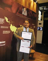 Darin Sukha of Cocoa Research Centre displays three awards received at the International Cocoa Awards, 2010