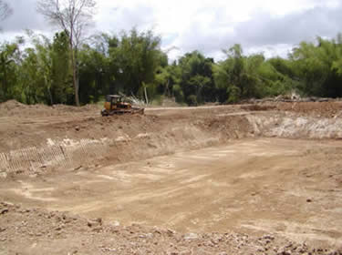 International Cocoa Genebank Trinidad - Photo of the construction stage of the irrigation pond, to be connected to a pipe network to distribute water throughout the ICGT. Click to view the finished pond.